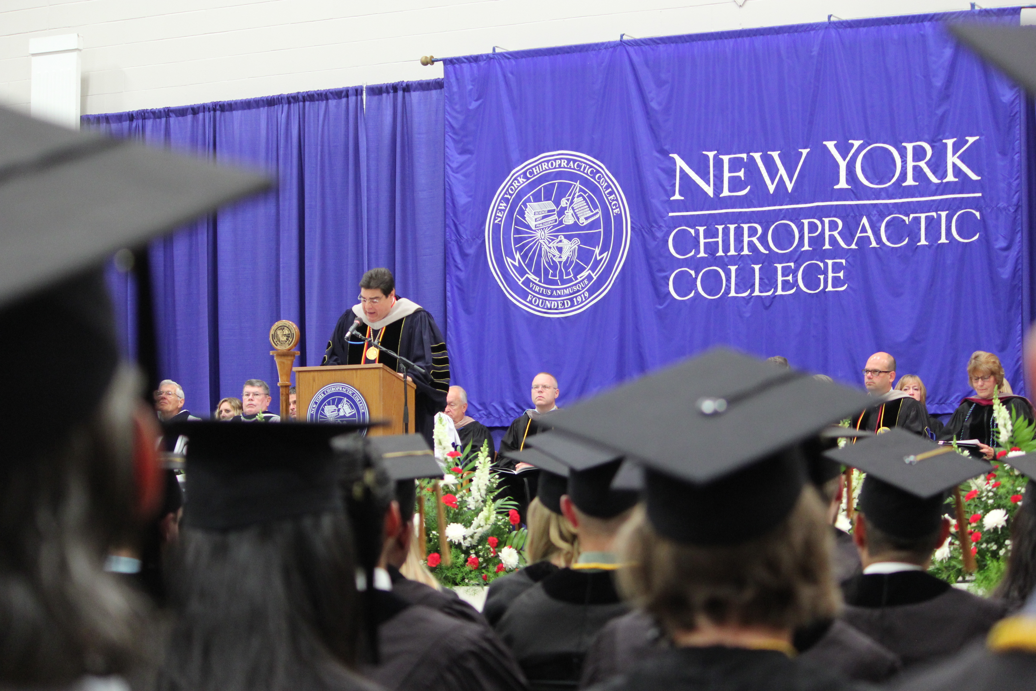 NYCC President, Dr. Frank. J. Nicchi speaking at the July Commencement exercises held at New York Chiropractic College.